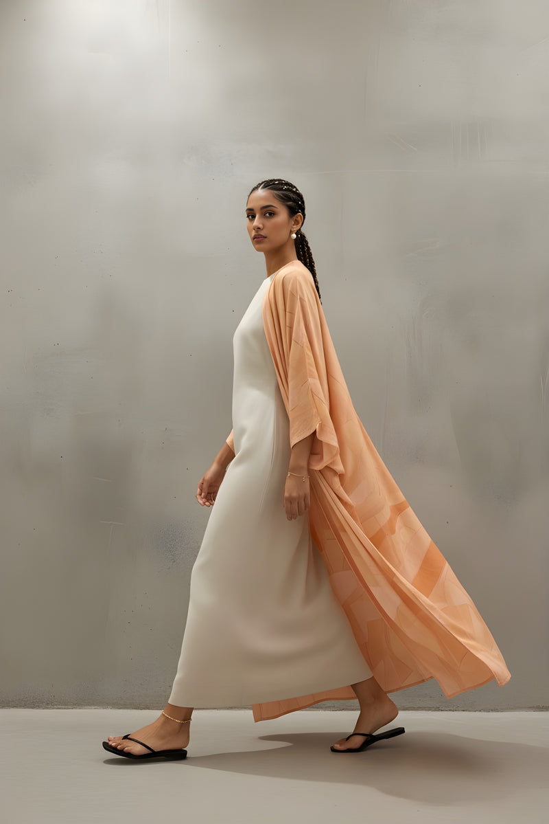 Blushed Without Warning Printed Matte Silk Abaya in Peach by The Untitled Project — luxury resortwear designed in Saudi.