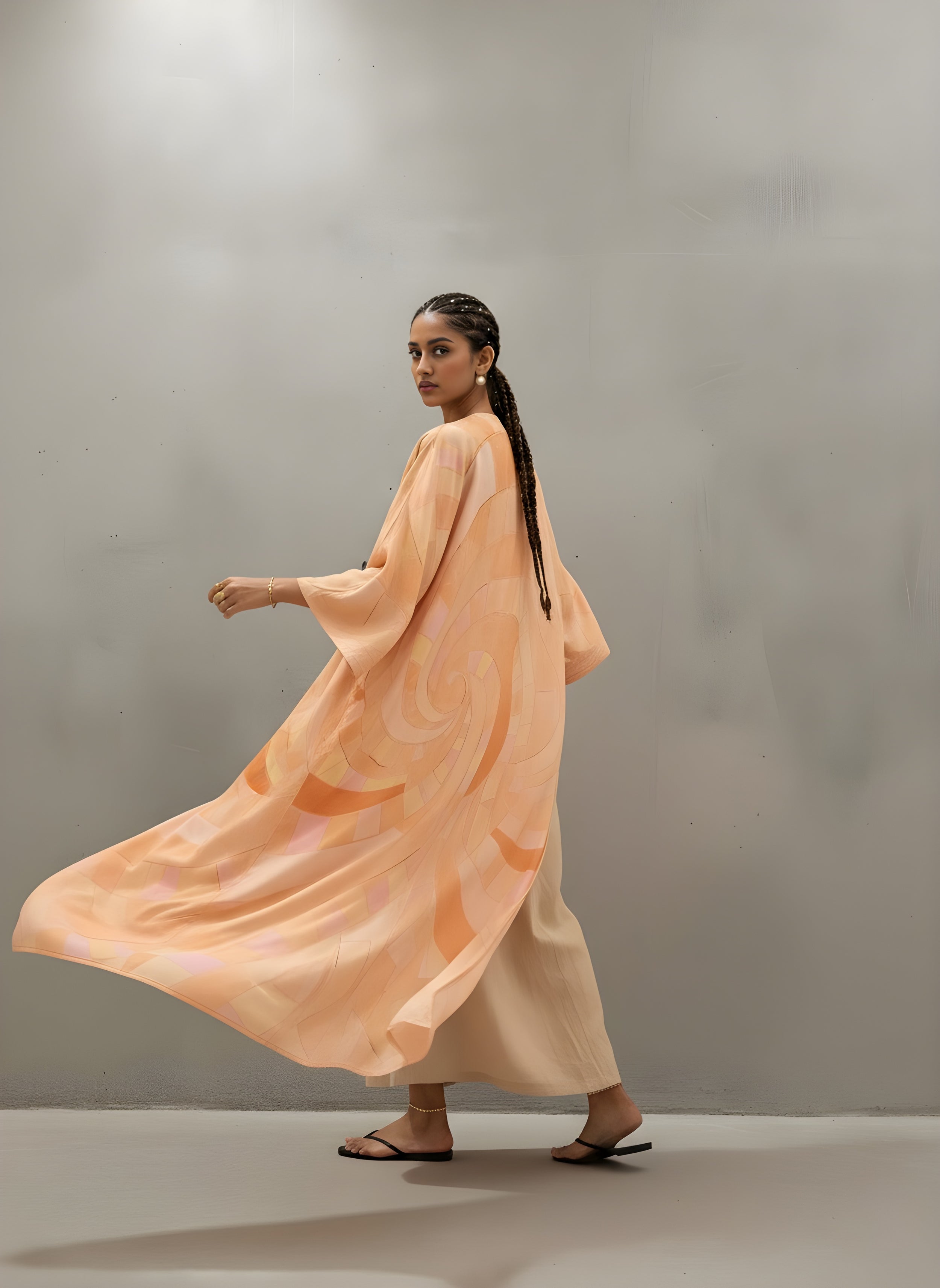 Printed peach silk abaya styled for resortwear — contemporary design by The Untitled Project Saudi.
