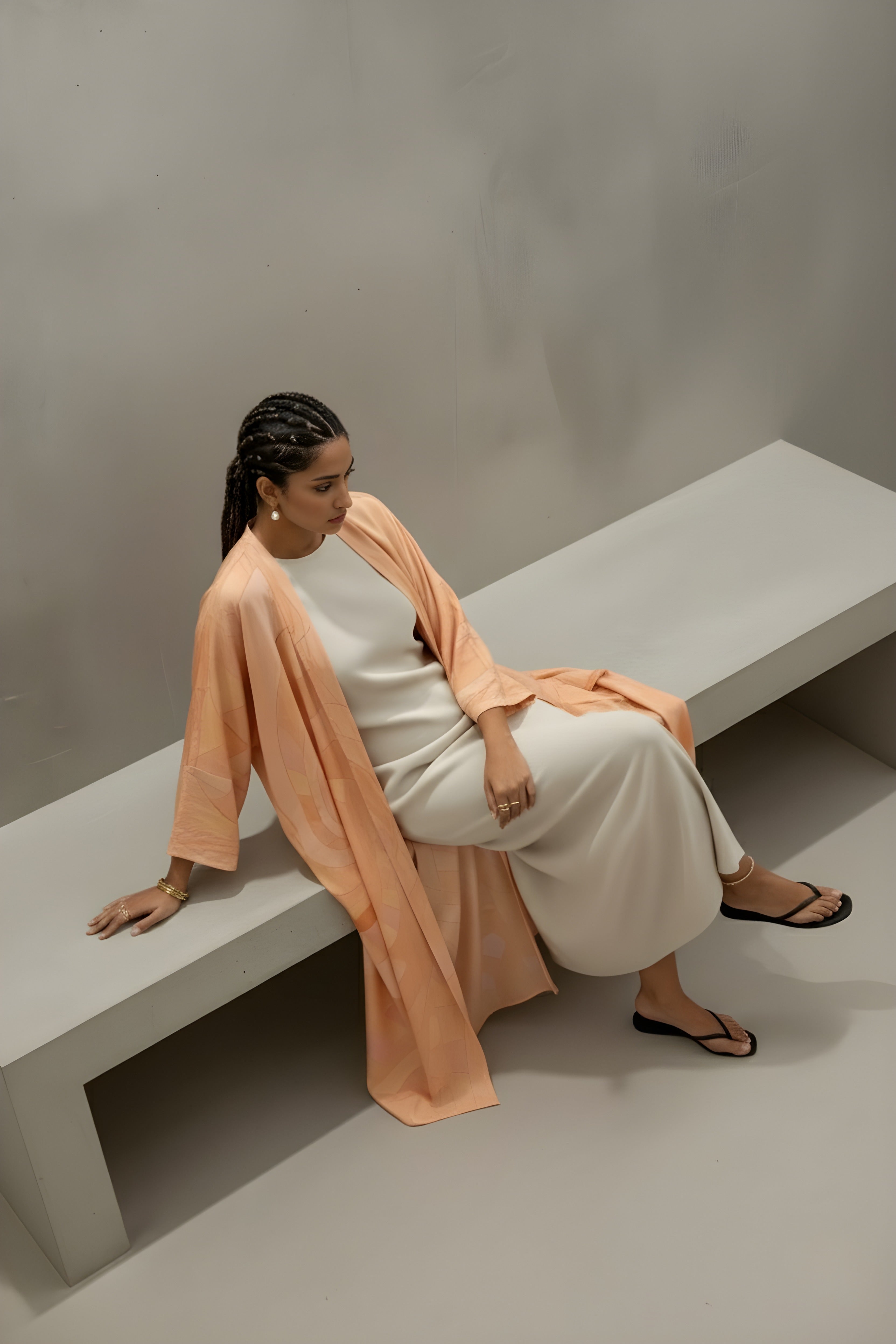 Model wearing peach printed matte silk abaya from The Untitled Project’s Blushed Without Warning collection — sustainable resortwear look.