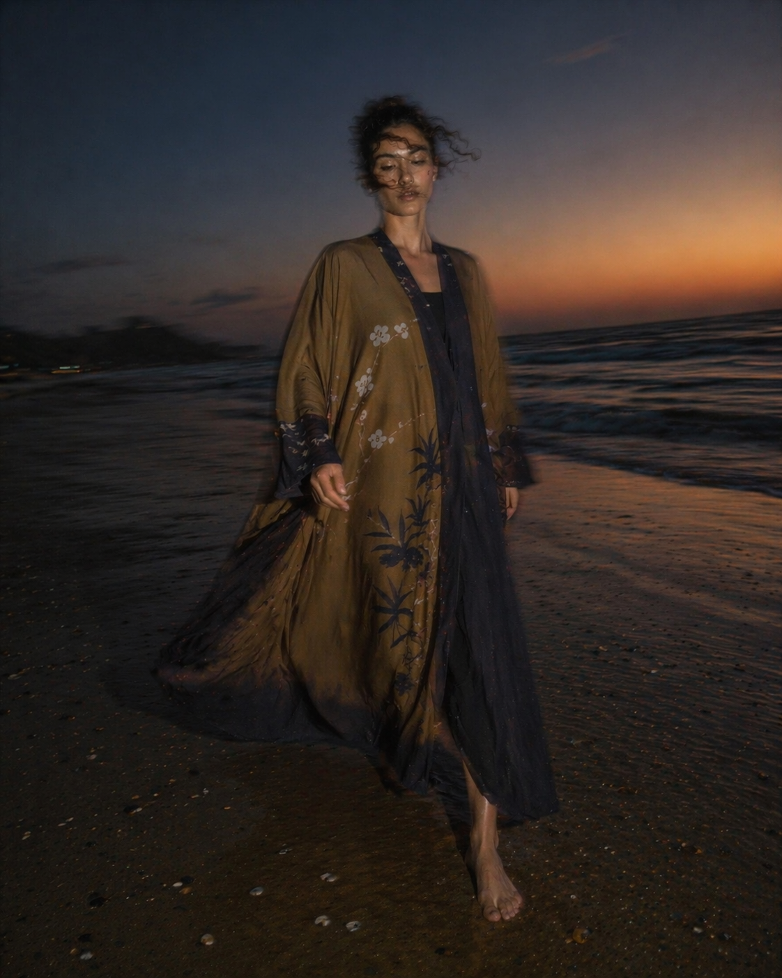 Model wearing a brown and navy open abaya with soft drape