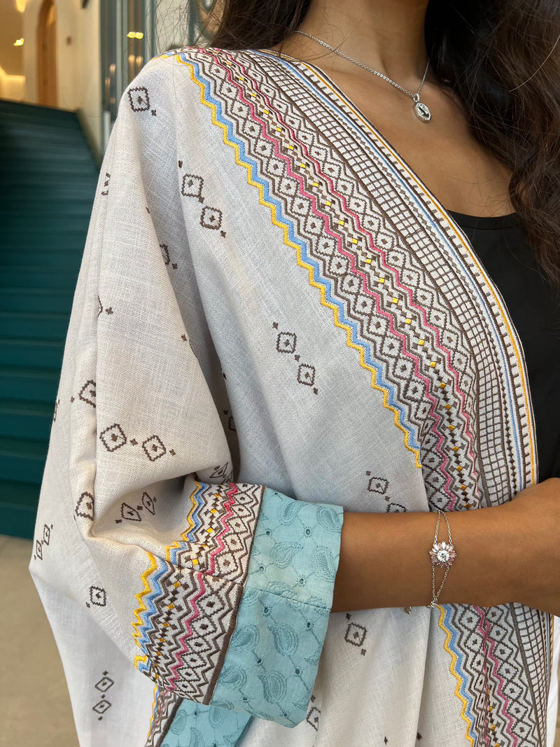Close-up of sleeve and chest area of Fatina Abaya showing intricate bohemian embroidery and soft blue cuff lining.