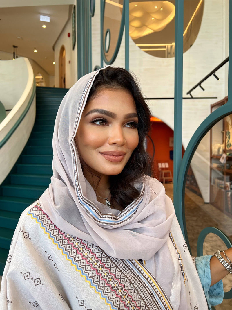 Model in Fatina Abaya & Scarf Set smiling with scarf draped over head, emphasizing the elegant neckline embroidery.