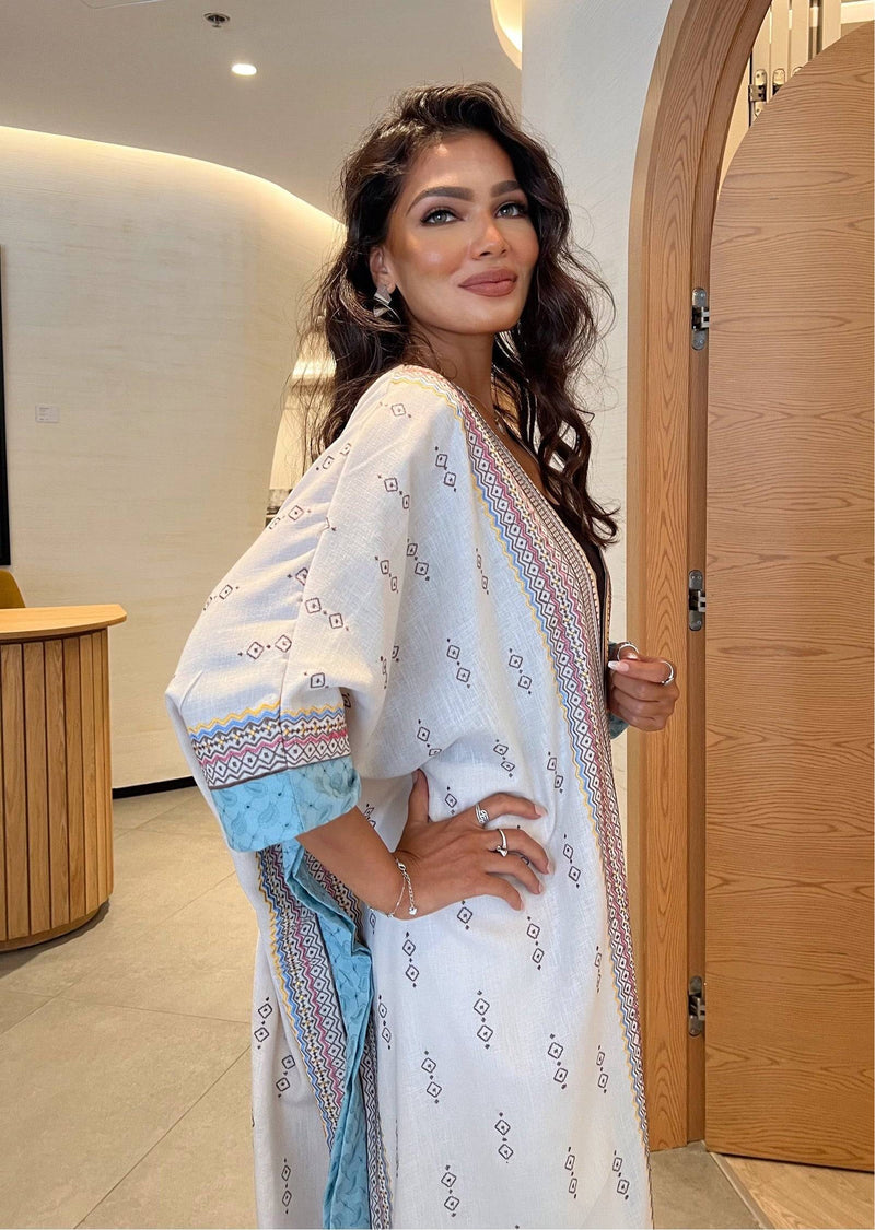 Model posing in Fatina Abaya with hand on hip, highlighting the relaxed fit and colorful embroidered trim.
