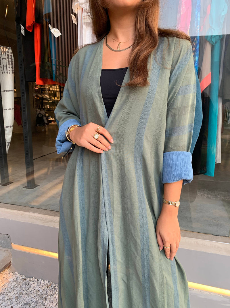 The WORKaholic Abaya - Daily Wear in green with vertical stripes, styled with minimal accessories for a clean look.