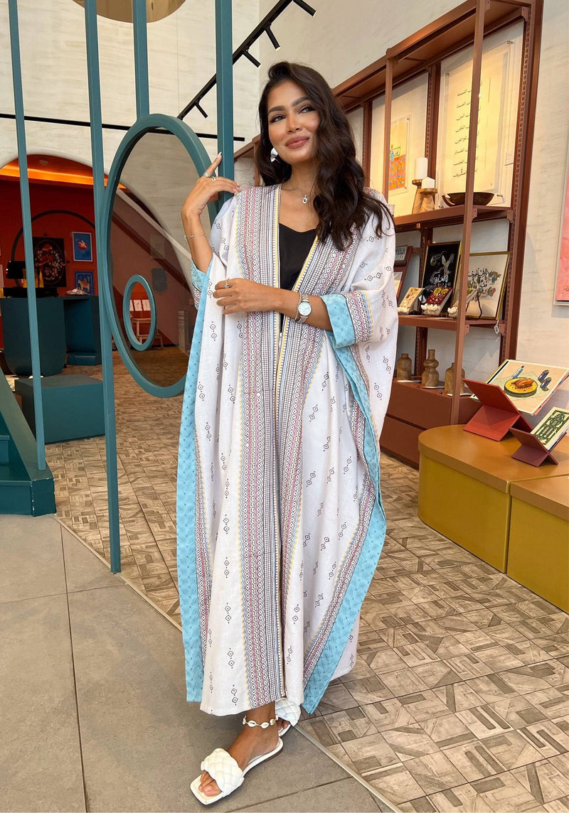 Full outfit view of Fatina Abaya & Scarf Set styled with white sandals, showcasing its elegant drape and colorful embroidery.