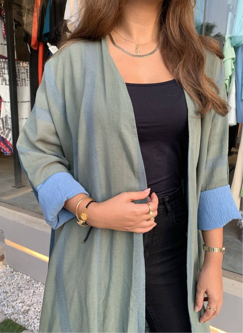 Front detail of The WORKaholic Abaya - Daily Wear in green, showing soft texture and rolled blue sleeves.