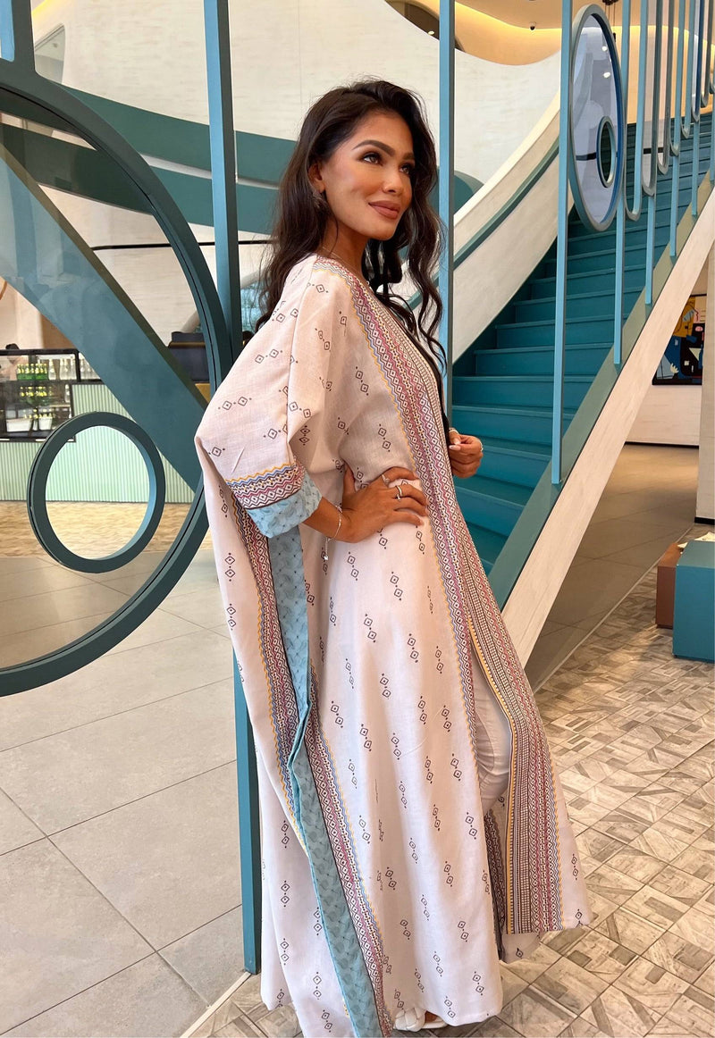 Fatina Abaya in boho chic design with colorful embroidery and blue inner lining, styled for a modern traditional look.