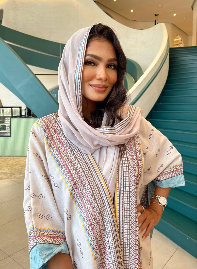 Model wearing Fatina Abaya & Scarf Set with soft pastel scarf, highlighting the embroidered neckline and relaxed fit.